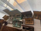 a table with many different types of pens and pencils on it