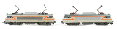 two toy trains on a white surface with a white background