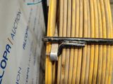 a close up of a yellow cable with a metal hook on it