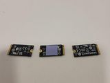 a close up of three small pieces of electronic equipment on a table