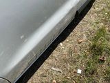 the car is parked on the side of the road in the grass