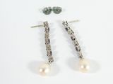 two pairs of pearl and diamond earrings on a white surface