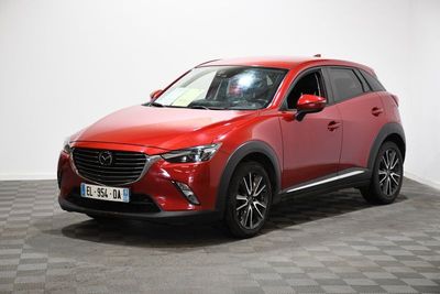 a red mazda cx - 3 parked on a checkered floor