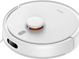 gros plan d'un aspirateur robot sur une surface blanche