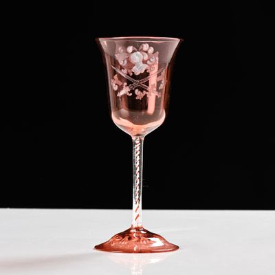 a wine glass that is sitting on a table