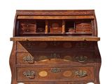 an old wooden desk with a drawer and a bowl on top of it