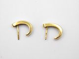 a pair of gold earrings on a white background