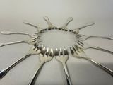 a lot of forks arranged in a circle on the table