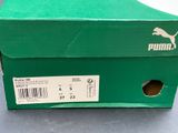 a green box with a tag on it on a table
