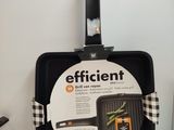 a black pan with a black handle on a white counter