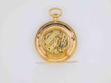 an image of a gold pocket watch sitting on a white surface