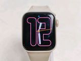 a white apple watch with a pink neon sign on it