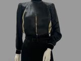 an image of a mannequin wearing a black dress with gold trims