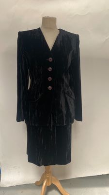black velvet jacket and skirt suit on a mannequin stand