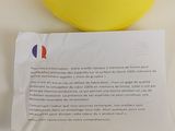 a yellow ball on the table next to a piece of paper