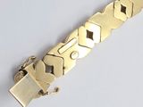 an image of a gold bracelet with a lock on a white background