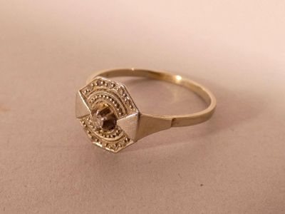 an image of a gold ring with a brown stone in it