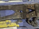 a pair of pliers that are sitting in a tool box