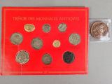 a close up of a red book with a bunch of coins on it