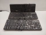two keyboards sitting on a table with wires attached to them
