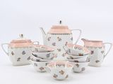 a white tea set with pink flowers on it