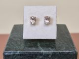 pair of diamond stud earrings sitting on a marble block