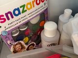 a bag of snazaroo paint and other supplies on the counter