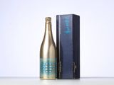 a bottle of champagne next to a box of wine