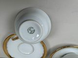 two cups and saucers sitting on a table