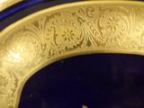 a close up of a gold plate with a blue background