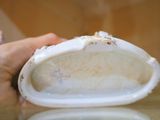 une personne tenant un sac à main blanc sur une table en verre