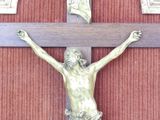 a statue of jesus on the cross on the wall