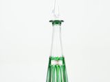 green and clear glass vase with a pointed top on a white background