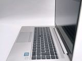 a silver laptop with a blue sticker on the screen