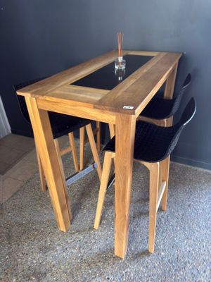 a table with two chairs and a glass on top of it