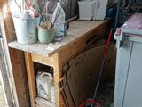 a mop that is sitting on the floor next to a table