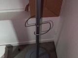a metal pole that is standing in the corner of a room