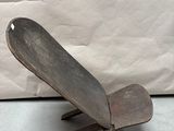a metal object that looks like a skateboard on a stand