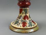 a vase that has a red and green design on it