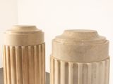 two vases that are sitting on a table