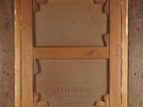 an image of a painting of a wooden frame with a label on it