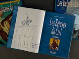 three books on a table with a drawing of a man on a horse and a drawing of a man on a horse and a drawing of a man on a horse