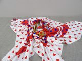 a red and white scarf with hearts on it