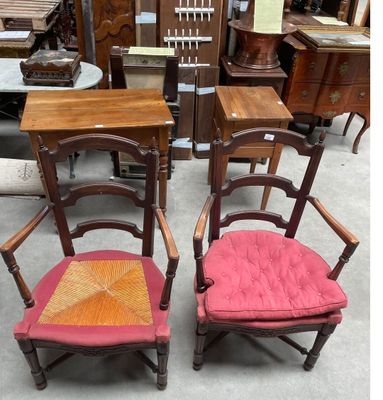 two wooden chairs with red cushions sit next to each other in a room