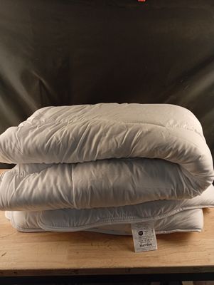 three pillows stacked on top of each other on a table