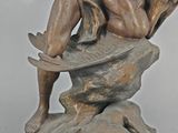 bronze statue of a man with a dog and a cat on a rock