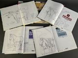 several pages of coloring books on a table with a horse in the background