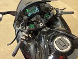 a close up of a motorcycle with a display on the dashboard