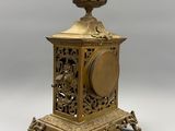a gold clock that is sitting on a table