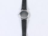 wrist watch on a white surface with a black strap